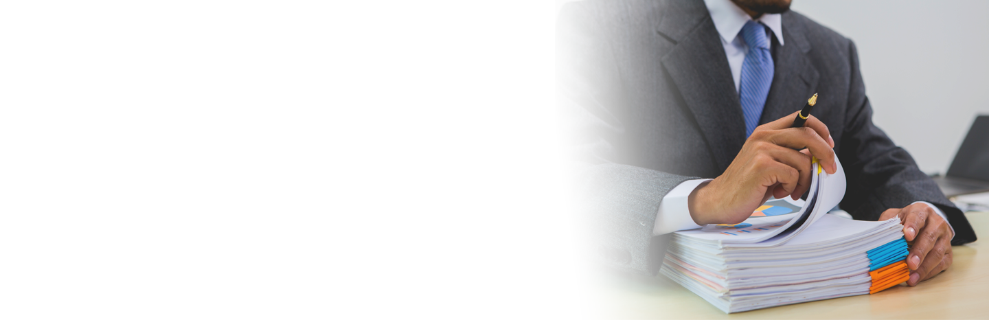 Man with a stack of documents on his desk