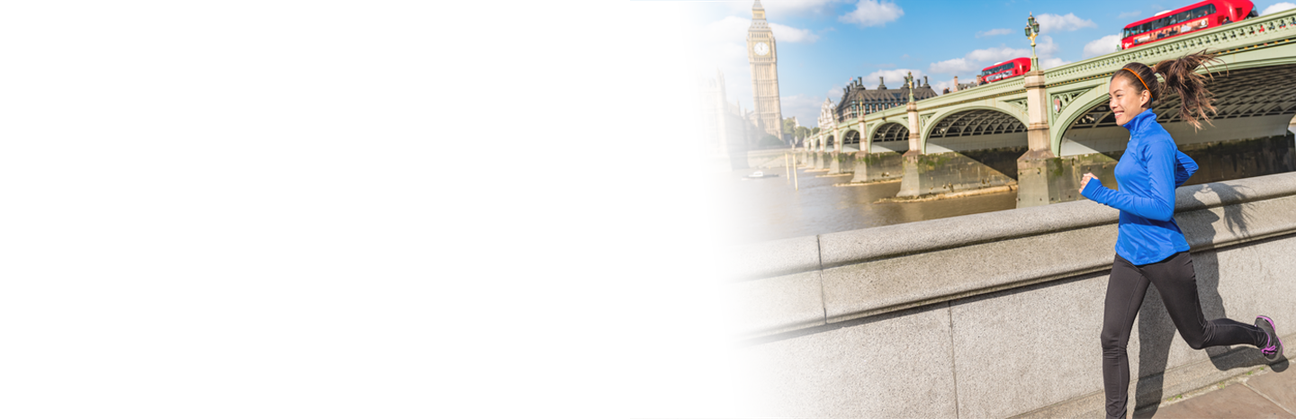 Young woman running by Westminster bridge in London, England